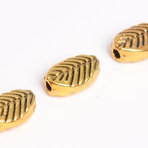 20 Pcs - 9x6MM Antique Gold Tone Leaf Spacer Beads (64273-2482)
