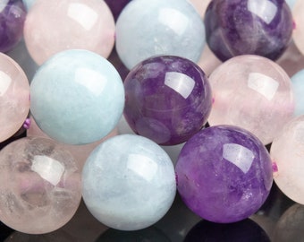 May include: A close-up of a strand of round, smooth beads in shades of pink, blue, and purple. The beads are made of natural stone and have a polished finish.