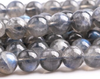 May include: A strand of round, gray labradorite beads with iridescent blue flashes. The beads are smooth and polished.