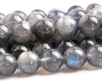 May include: A strand of round, gray labradorite beads with iridescent blue and green flashes. The beads are smooth and polished.