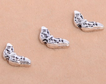 May include: Three silver butterfly charms with intricate details. The charms are small and delicate, perfect for adding a touch of whimsy to jewelry or crafts.