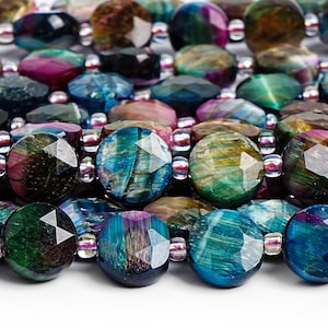 May include: Close-up of a beaded bracelet featuring faceted, oval-shaped beads in shades of teal, purple, green, and brown. The beads are strung together with small, clear spacer beads. The overall design is colorful and eye-catching.