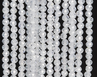May include: A strand of clear faceted glass beads. The beads are round and have a shiny finish.