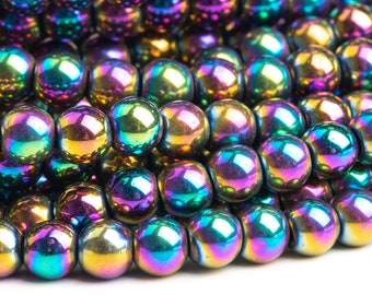 May include: A strand of iridescent rainbow hematite beads. The beads are round and smooth, with a high polish. They are a deep black color with a rainbow sheen.