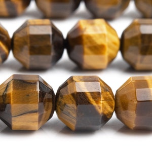 May include: Close-up of faceted tiger's eye gemstone beads. The beads are a mix of brown and gold, with a polished, reflective surface. The geometric cut of the beads creates multiple facets, enhancing their natural luster. These beads are ideal for jewelry making.