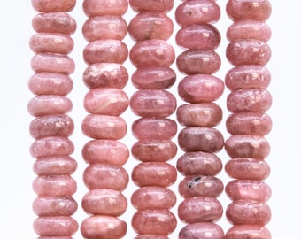 May include: A strand of pink and white gemstone beads. The beads are oval shaped and have a smooth, polished finish.