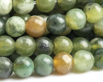 May include: A strand of round, green and brown jade beads. The beads are smooth and polished, with a natural, mottled appearance.