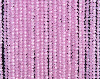 May include: A strand of pink faceted glass beads. The beads are small and round, and they have a shiny, iridescent finish.