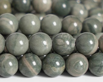 May include: Close-up of a collection of round, polished beads in shades of green and grey. The beads have a smooth, glossy finish and vary in pattern, with some showing veining. These beads are likely used for jewellery making.