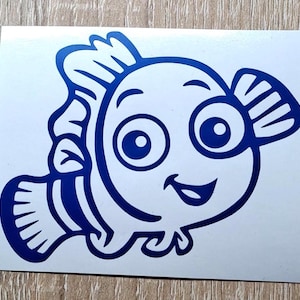Puede incluir: Un pez de dibujos animados azul con ojos grandes y una sonrisa. El pez tiene una aleta en la espalda y una cola con rayas.