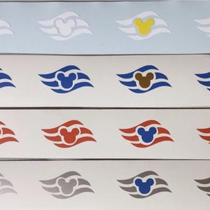 May include: A collection of colorful decals featuring the iconic Mickey Mouse head within a stylized wave design. The decals come in various colors, including blue, red, yellow, and gray, and are arranged in rows.