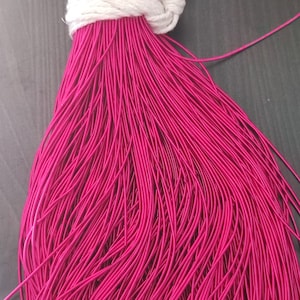 May include: A large bundle of bright pink elastic cord, tied with a white string.