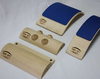 May include: Four wooden back support tools with the brand name "Sae arc" printed on each. Two of the tools have a blue foam pad on top. One tool has three wooden balls attached to the top.