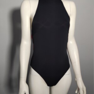 May include: A black halter-style swimsuit with a high neckline.