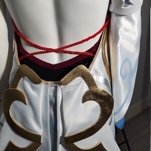 May include: White and blue costume with gold and blue cloud designs. The costume has a red rope tied around the waist.