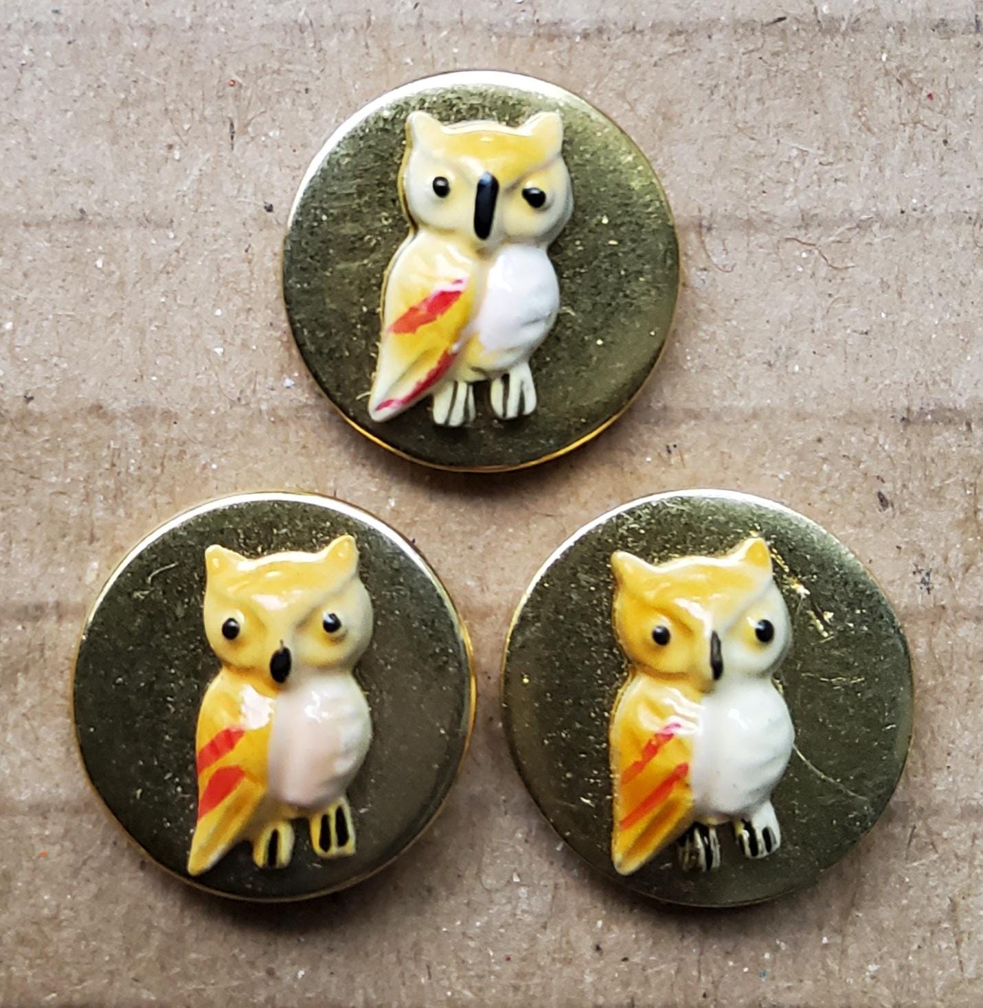 Set of three small unusual brass owl buttons.