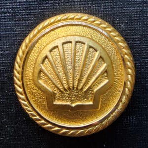Vintage brass Firmin SHELL uniform button.