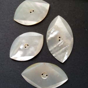 Vintage set of four Art Deco mother of pearl buttons.