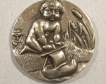 Silver button of baby with boat - early 1900's.