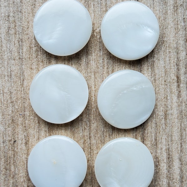 Vintage set of six white mother of pearl buttons.