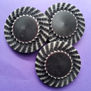 Vintage trio of large b/w coat buttons.