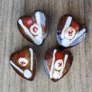 Vintage set of four arts and craft heart shaped enamel buttons.