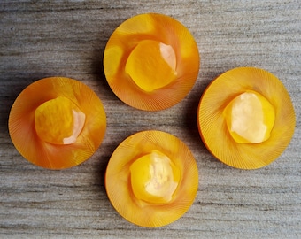 Vintage set of four large orange 1930's coat buttons.