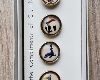 Vintage boxed set of 1950's promotional Guinness buttons.