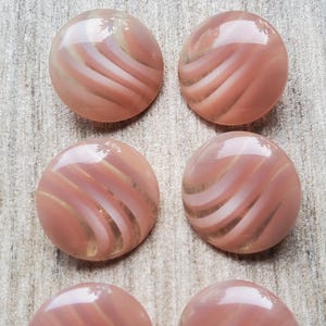 Vintage set of six pink acrylic buttons.