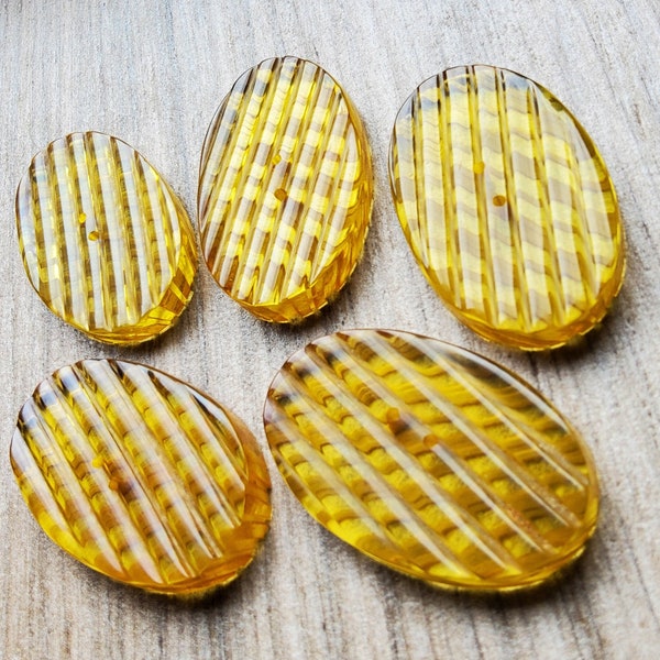 Vintage set of five large 1930's clear 'apple juice' buttons.