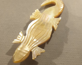 Large hand carved mother of pearl lizard button.