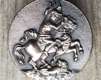 Vintage coppered silver button of horse back rider slaying lion.
