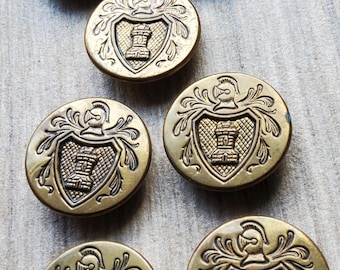 Vintage set of seven castle chess brass jacket buttons.