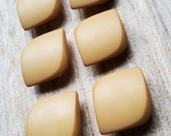 Vintage set of six biege plastic coat buttons.
