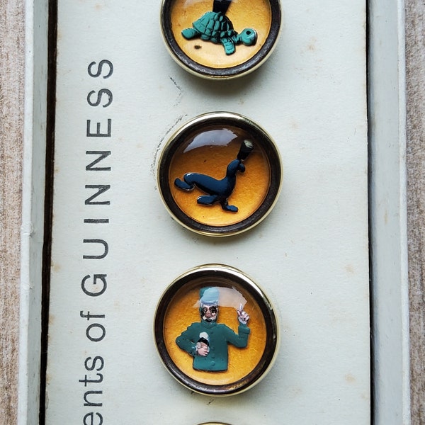 Vintage boxed set of 1950's promotional Guinness buttons.