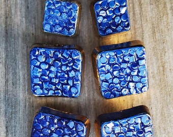 Vintage set of eight blue and gold metalized buttons.