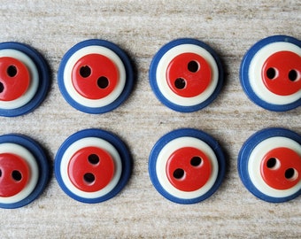 Vintage set of eight small red, white and blue shirt buttons.