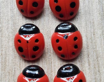 Vintage set of six ladybird childrens cardigan buttons.