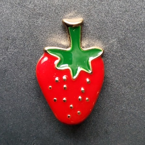 Botão de metal esmaltado em formato de morango.