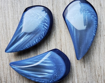Vintage set of three large tear shaped lucite coat buttons.