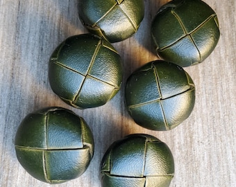 Vintage set of large dark green leather buttons.