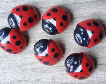 Vintage set of six red plastic ladybird buttons.