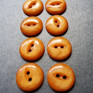 Vintage set of eight marbled orange shirt buttons.