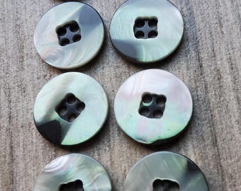 Set of eight faux mother of pearl jacket buttons.
