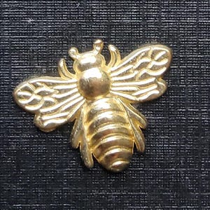 Vintage gold metal Bee shirt button.