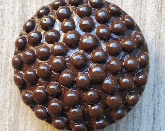 Vintage large phenolic resin molded button.