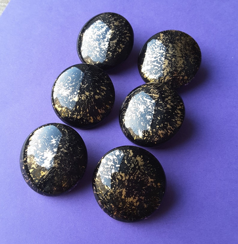 Vintage set of six large black and gold glass buttons.