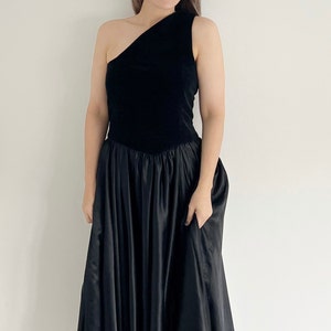 A handmade prom dress in black velvet and silky material.  The dress is full circle and has one shoulder.  Great for parties.  UK 12 14