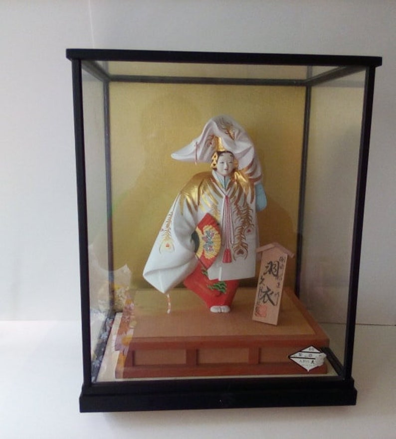 japanese doll in glass case