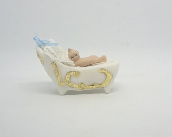 porcelain cradle and Kewpie doll